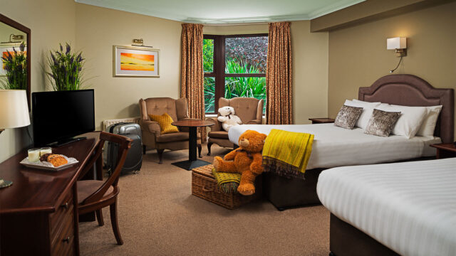 Family Room at Oranmore Lodge Hotel. A picture of a room with two beds and a giant teddy bear. Oranmore Lodge Hotel is an ideal place for a family hotel break with lots of spacious family rooms in the hotel.